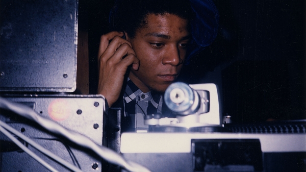 JEAN-MICHEL BASQUIAT DJ-ING IN THE LOUNGE AT AREA, 1986